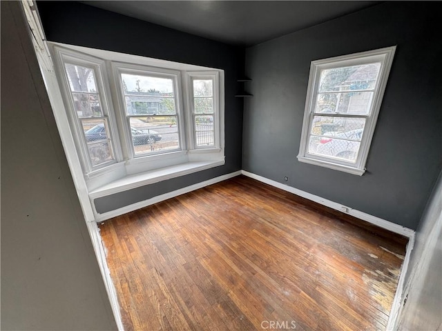 unfurnished room with dark hardwood / wood-style flooring