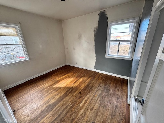 empty room with wood finished floors and baseboards