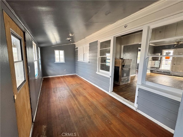 unfurnished sunroom featuring vaulted ceiling