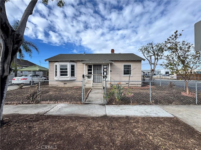 bungalow featuring a gate and a fenced front yard