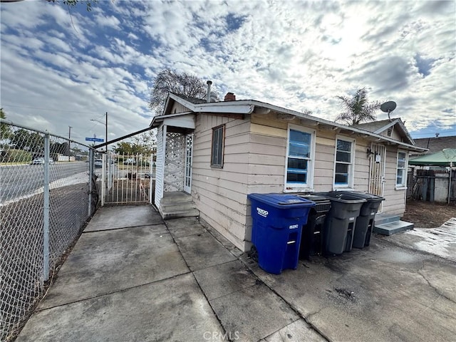 view of property exterior with a patio