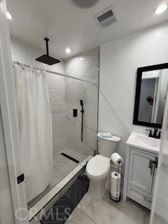 bathroom featuring vanity, toilet, and walk in shower