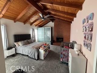 bedroom with a fireplace, vaulted ceiling with beams, ceiling fan, wood ceiling, and dark carpet