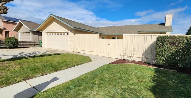 view of side of home featuring a yard and a garage