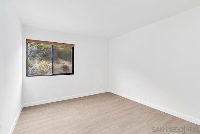 unfurnished room with light hardwood / wood-style flooring