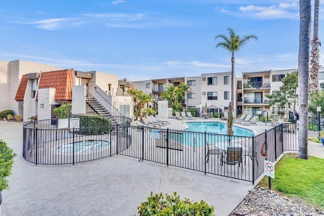 view of pool featuring a community hot tub and a patio area