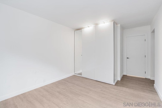 spare room with light wood-type flooring