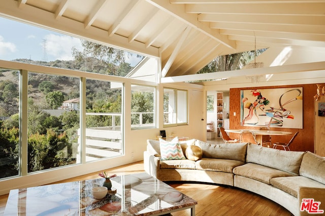 sunroom / solarium with vaulted ceiling with beams