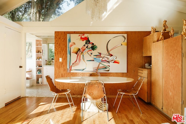 dining area featuring an inviting chandelier and light hardwood / wood-style flooring