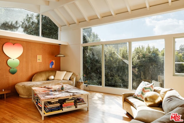 sunroom / solarium with lofted ceiling with beams