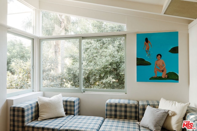 sunroom / solarium featuring lofted ceiling