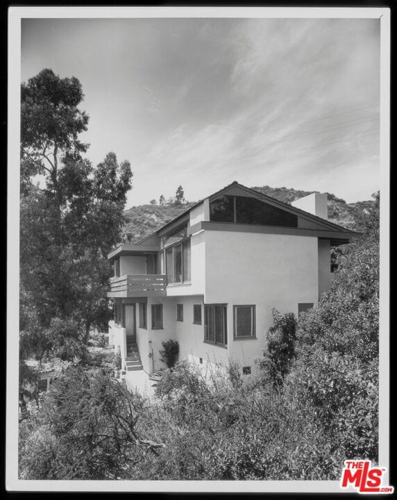 view of side of home with a balcony