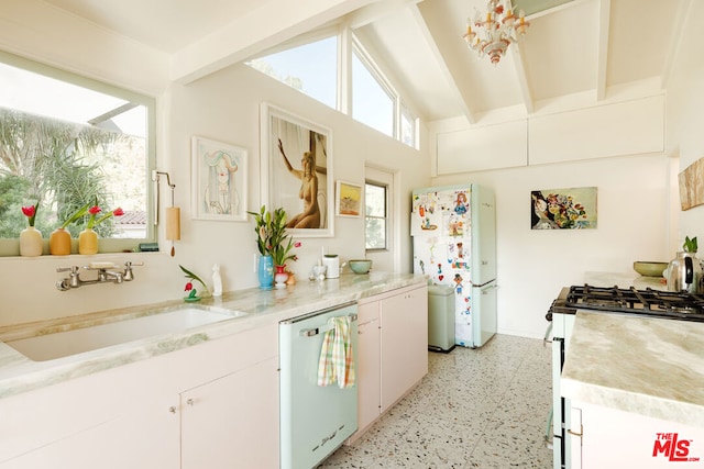 kitchen with sink, white appliances, vaulted ceiling with beams, and white cabinets