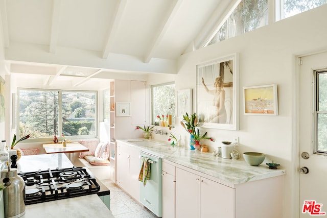 kitchen featuring a wealth of natural light, white cabinetry, sink, stainless steel dishwasher, and beam ceiling