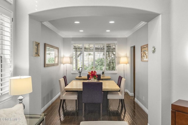 dining space with ornamental molding and dark hardwood / wood-style floors