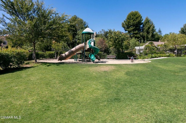 view of playground with a lawn