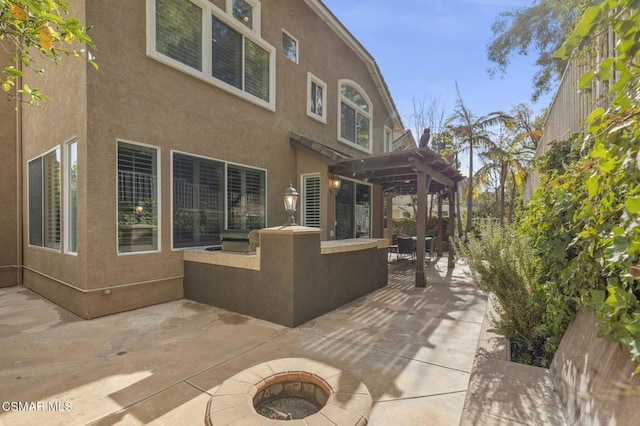 view of patio featuring a fire pit and a pergola