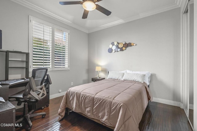 bedroom featuring ornamental molding, dark wood-type flooring, and ceiling fan