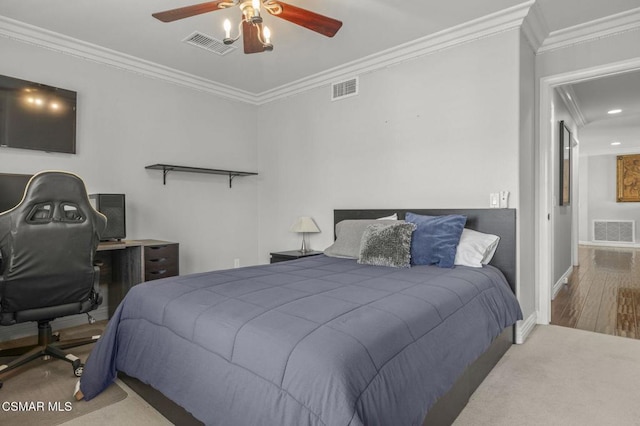 bedroom with ornamental molding, wood-type flooring, and ceiling fan