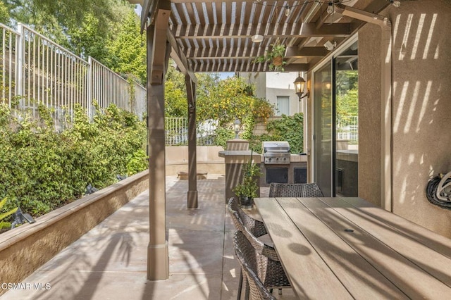 view of patio featuring area for grilling and a pergola