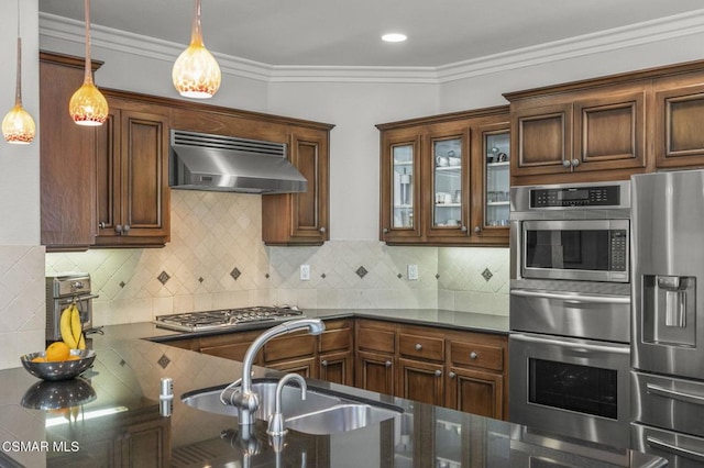 kitchen featuring extractor fan, appliances with stainless steel finishes, sink, and pendant lighting