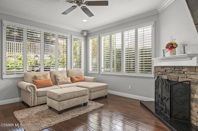 living room featuring ceiling fan, a fireplace, ornamental molding, and dark hardwood / wood-style floors