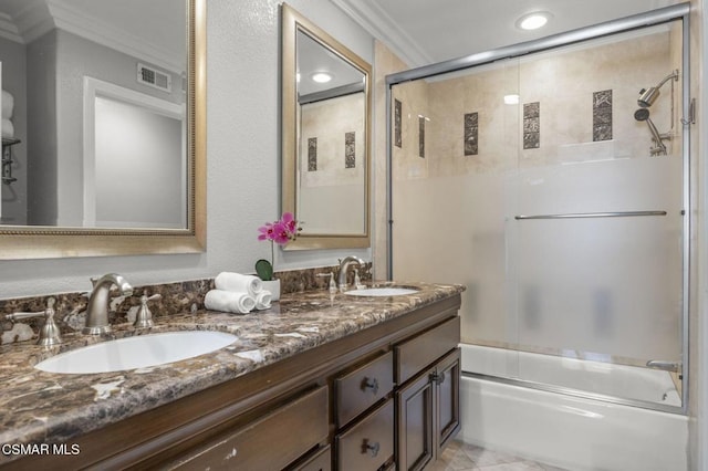 bathroom featuring crown molding, vanity, and shower / bath combination with glass door