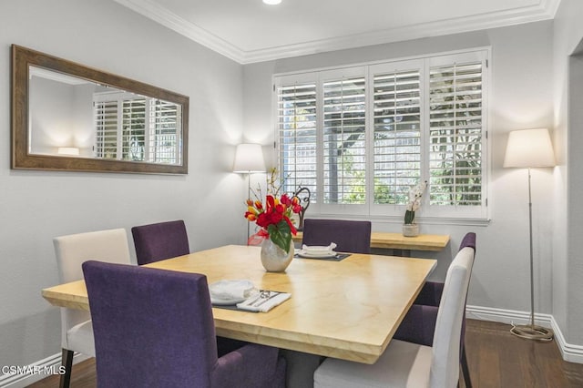 dining room featuring crown molding and dark hardwood / wood-style floors