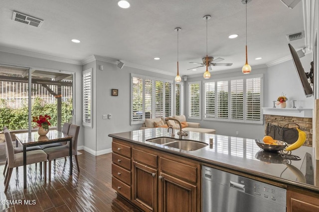 kitchen featuring a fireplace, dishwasher, sink, ornamental molding, and dark wood-type flooring