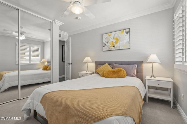 carpeted bedroom with crown molding, ceiling fan, and a closet