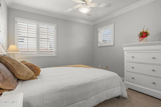 carpeted bedroom featuring crown molding and ceiling fan