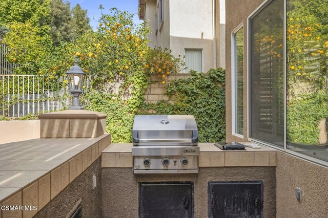 view of patio featuring area for grilling and a grill