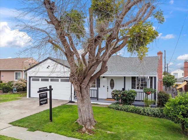 ranch-style house featuring a garage, covered porch, and a front lawn