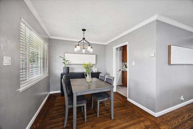 dining area with ornamental molding, dark hardwood / wood-style flooring, and a chandelier