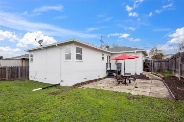 back of house featuring a yard and a patio