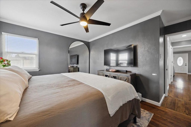 bedroom with dark hardwood / wood-style flooring, ornamental molding, and ceiling fan