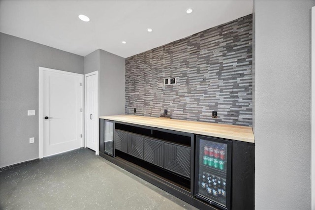 bar with concrete flooring and wooden counters