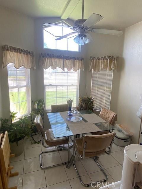 tiled dining space featuring ceiling fan