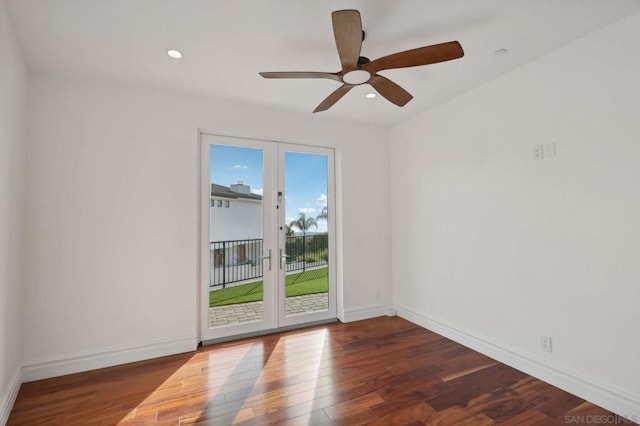 spare room featuring dark hardwood / wood-style floors, ceiling fan, and french doors