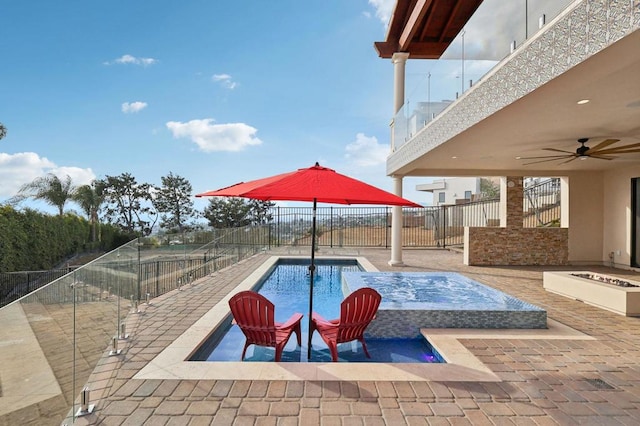 view of swimming pool with a patio area, ceiling fan, and an outdoor fire pit