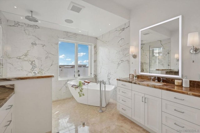 bathroom with vanity, separate shower and tub, and tile walls