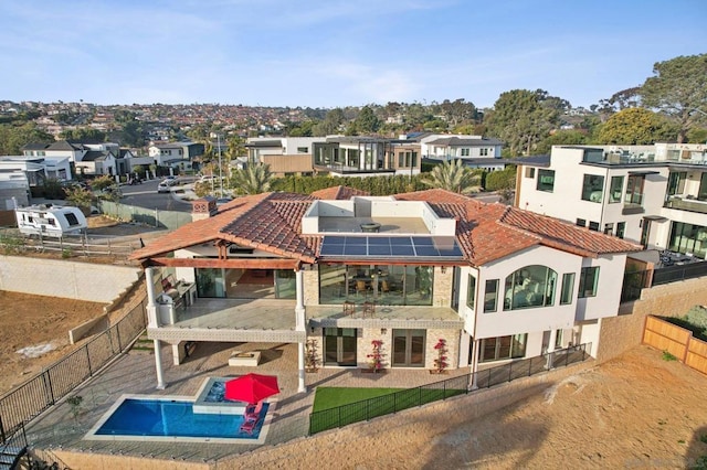 back of house featuring solar panels