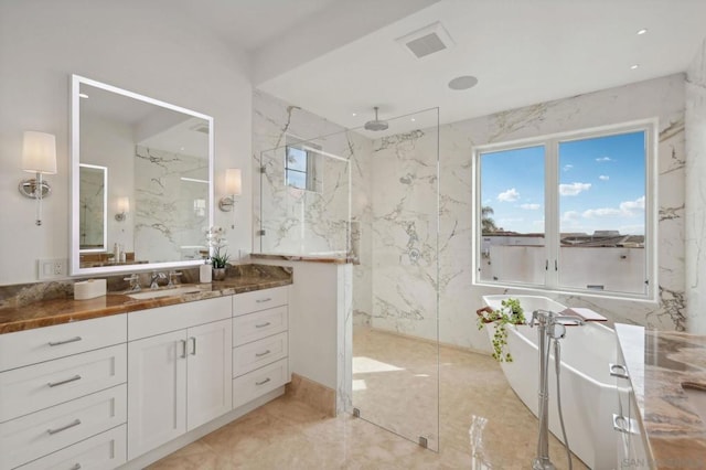 bathroom featuring vanity and independent shower and bath