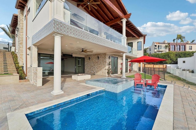 view of swimming pool with a patio area, ceiling fan, and an in ground hot tub