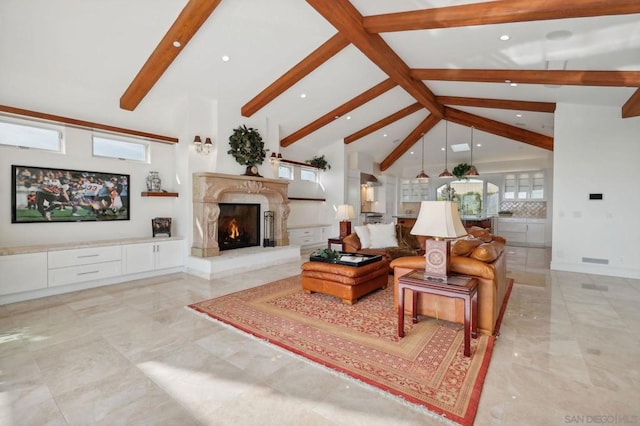 living room featuring beam ceiling, a fireplace, high vaulted ceiling, and plenty of natural light