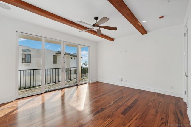 spare room with ceiling fan, wood-type flooring, and beamed ceiling