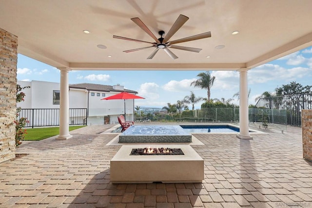 view of patio / terrace featuring ceiling fan, an outdoor fire pit, and a fenced in pool