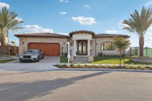 mediterranean / spanish home with a garage, a front lawn, and french doors