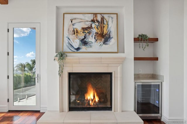 details featuring wine cooler and hardwood / wood-style floors