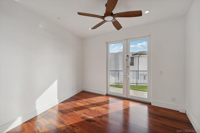 empty room featuring hardwood / wood-style floors, a wealth of natural light, ceiling fan, and french doors